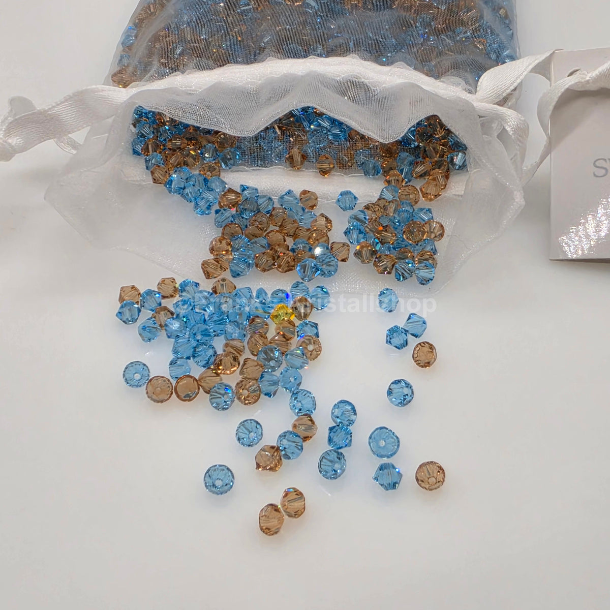 SWAROVSKI Kristall Dekosteine Doppelkegel Perlen 4 mm Blau-Braun