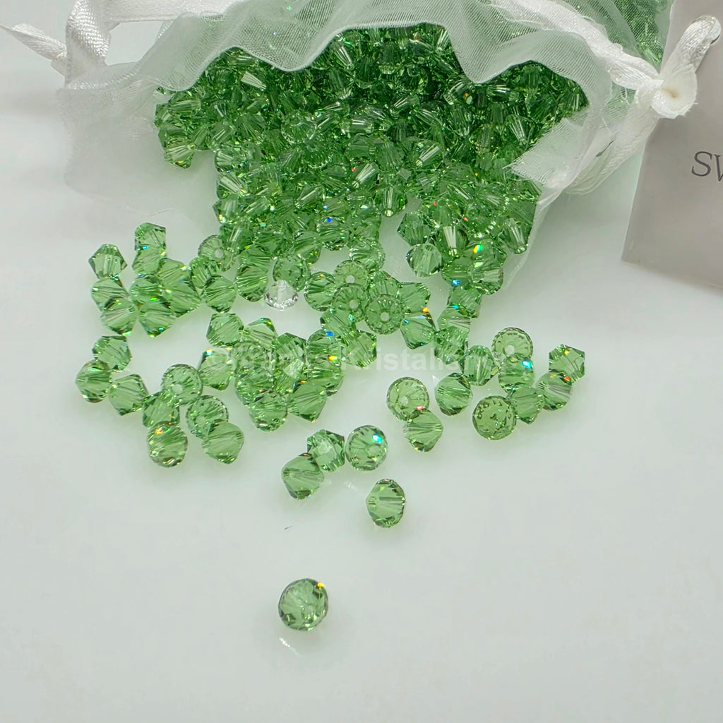 SWAROVSKI Kristall Dekosteine Doppelkegel Perlen 4 mm  Peridot Grün